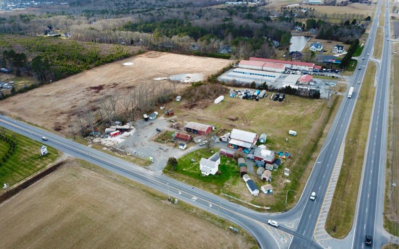 The 15-acre Chappell Farm parcel is an L-shape northwest of the Cave Neck Road-Route 1 intersection. Developers are proposing a mix of apartments (rear of the parcel) and commercial buildings (frontage along Route 1). The existing buildings would be torn down. NICK ROTH PHOTO